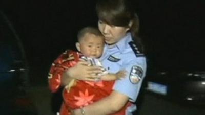 Police officer holding child