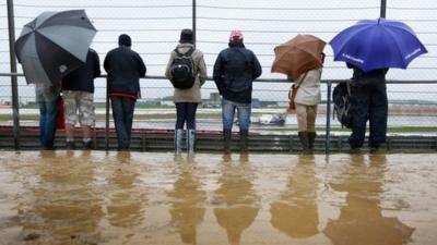 Fans watch in wet and muddy conditions during practice for the British Grand Prix at Silverstone