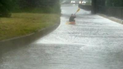 Man canoes down road