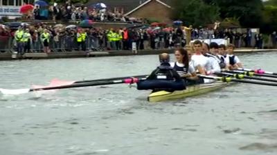 Sir Steve Redgrave and crew row with the Olympic flame