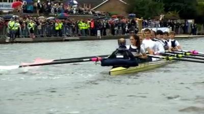 Sir Steve Redgrave and crew row with the Olympic flame