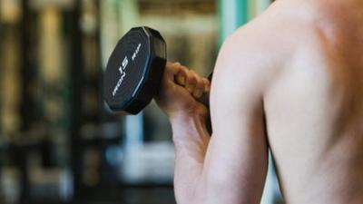 Anonymous man working out in the gym