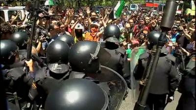 Spanish riot police and protesters