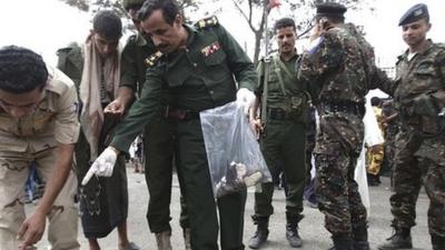 Forensic policemen collect evidence at the scene of the blast