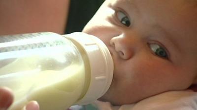 A baby being bottle fed