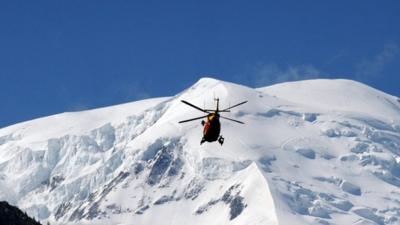 A rescue crew of the Securite Civile (emergency services) flies over the Mont Blanc