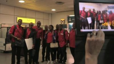 Olympic athletes pose for photo at Heathrow Airport