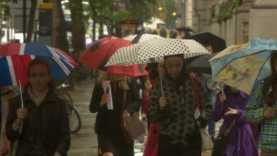 Shoppers with umbrellas