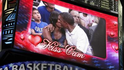 Obamas kissing on "kiss cam" screen