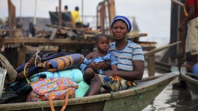 A woman sits in a canoe in Lagos