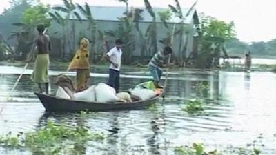 People in a boat with their belongings