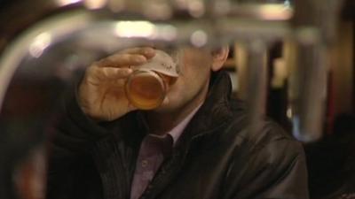 A man drinking a pint