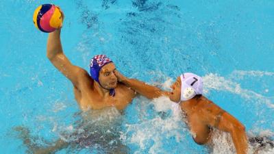 Hungarian and Croatian water polo players clash