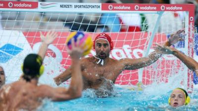 Hungarian and Australian water polo players in action