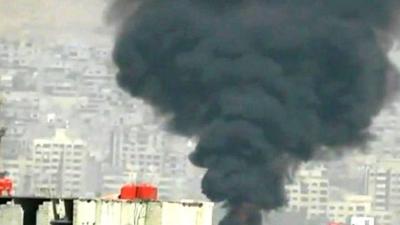 Still from unverified footage purports to show smoke rising from Damascus skyline