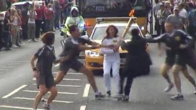 Officers tackle teenager as he tries to grab the Olympic torch in Gravesend, Kent