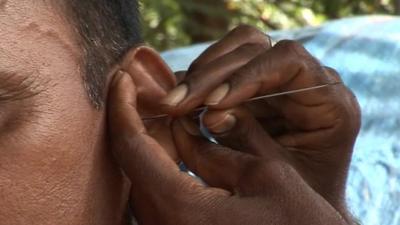 Ear being cleaned