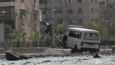 Abandoned minivan in middle of glass-strewn street