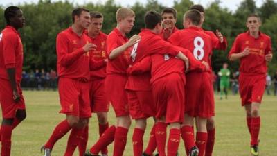 Liverpool players celebrate their victory over County Antrim