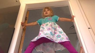 Sofya Dickson, 3, climbing a door frame