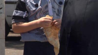 A child holds bread