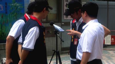 Inspectors from Taipei's Department of Environmental Protection read a sound level meter in Taipei, Taiwan, 16 July 2012