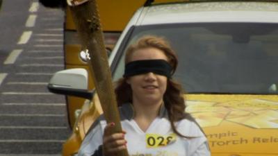 Mia Rathband carrying the Olympic torch