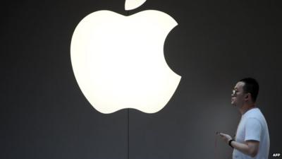 Man walks past the Apple logo