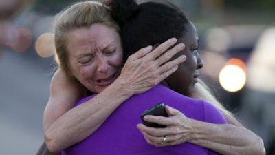 Mourners embrace in Aurora, Colorado