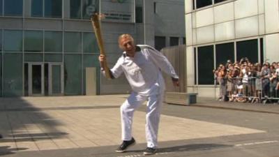 Sir Bruce Forsyth with the Olympic flame