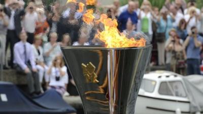 The Olympic flame burning in the cauldron on the royal barge Gloriana