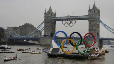Olympic rings and royal barge on Thames