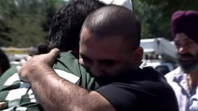 Distraught family members outside Sikh temple in Wisconsin