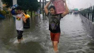 Two residents in a flooded area of Manila