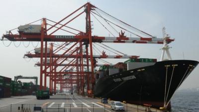 A cargo ship lands alongside a quay in Tokyo