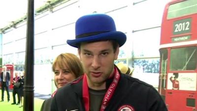 USA fencer shows off the hat he traded at the closing ceremony