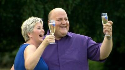 Adrian and Gillian Bayford holding glasses of Champaign