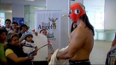 A Mexican wrestler talking to fans