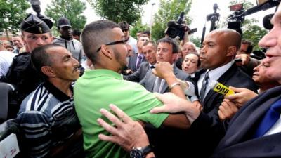 French Interior Minister Manuel Valls (centre) is heckled