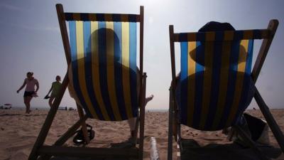 Sunbathers in deck chairs