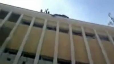 Rebels appear to throw body from building