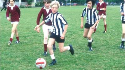 Schoolboys playing football.