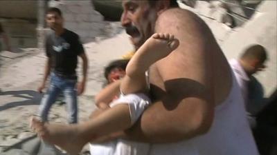 Man carrying injured child