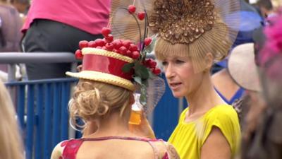 Two ladies wearing hats talking