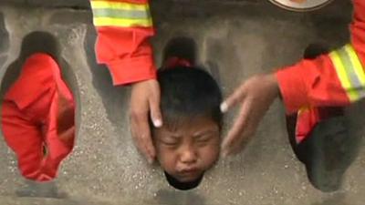 Boy gets head stuck in balcony frame