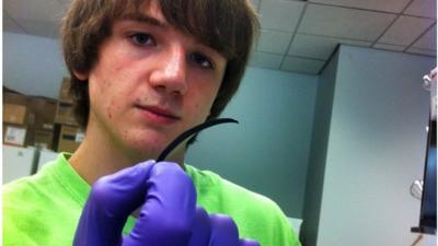 Jack Andraka holding sensor strip