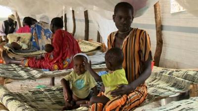 A mother with her two children at Batil refugee camp