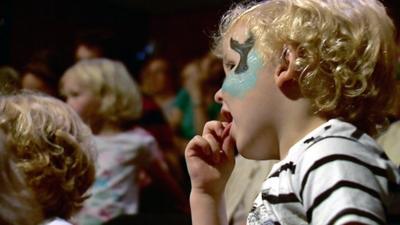 Children watch a performance at the festival