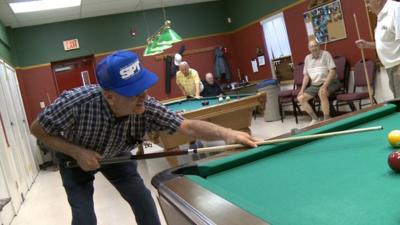 Senior citizens playing pool