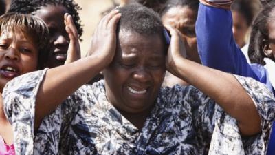 A woman cries as she protests against police near the Lonmin mine in South Africa. Photo: 17 August 2012